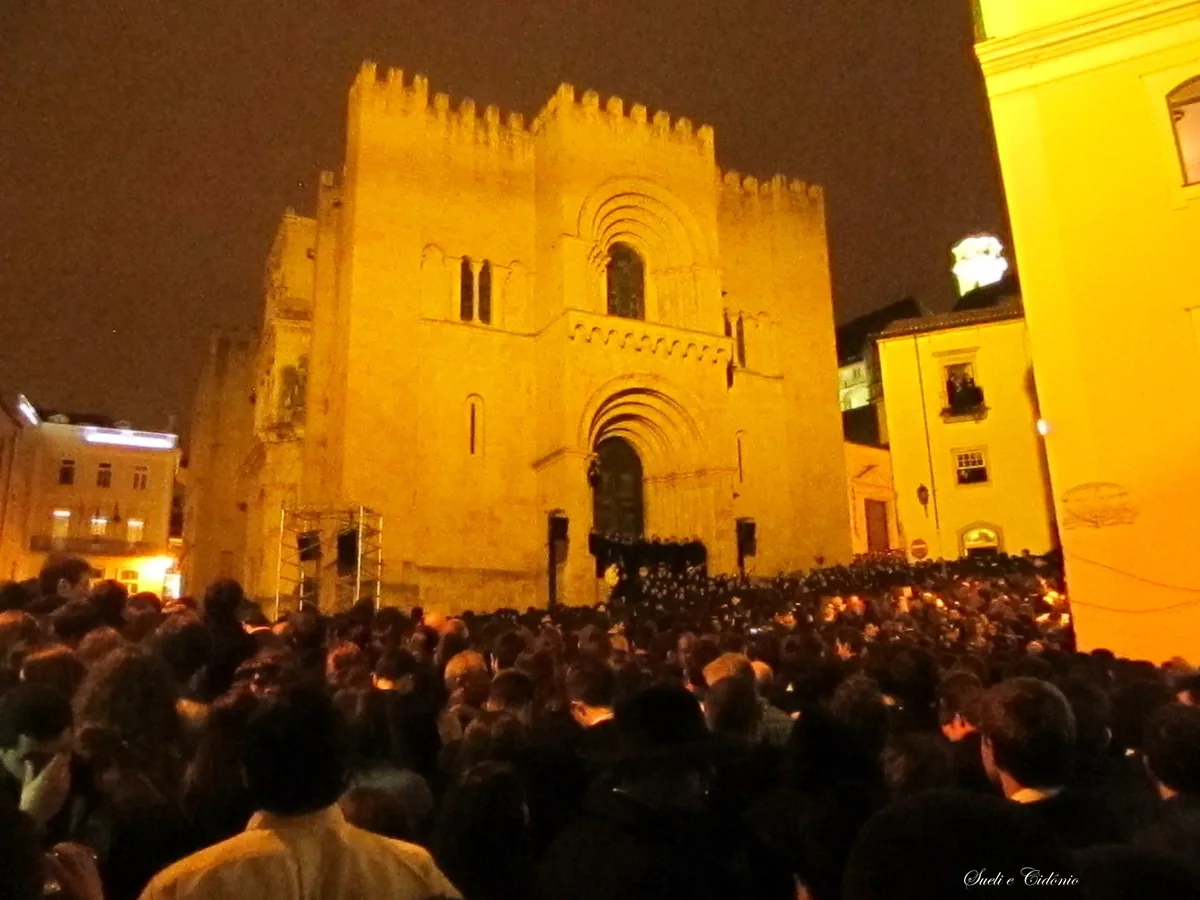 Students in black academic capes singing on the steps of the S&eacute; Velha during the Serenata Monumental
