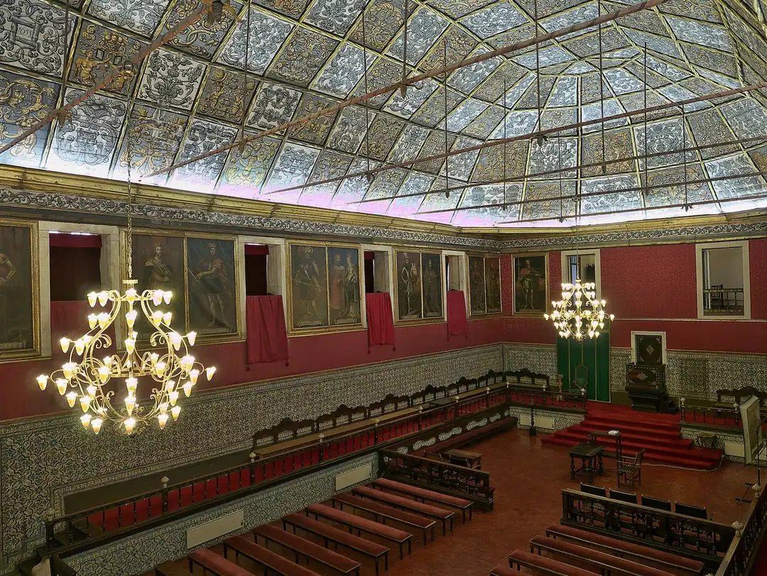 The Sala dos Capelos at the University of Coimbra, with its painted coffered ceiling and rows of royal portraits