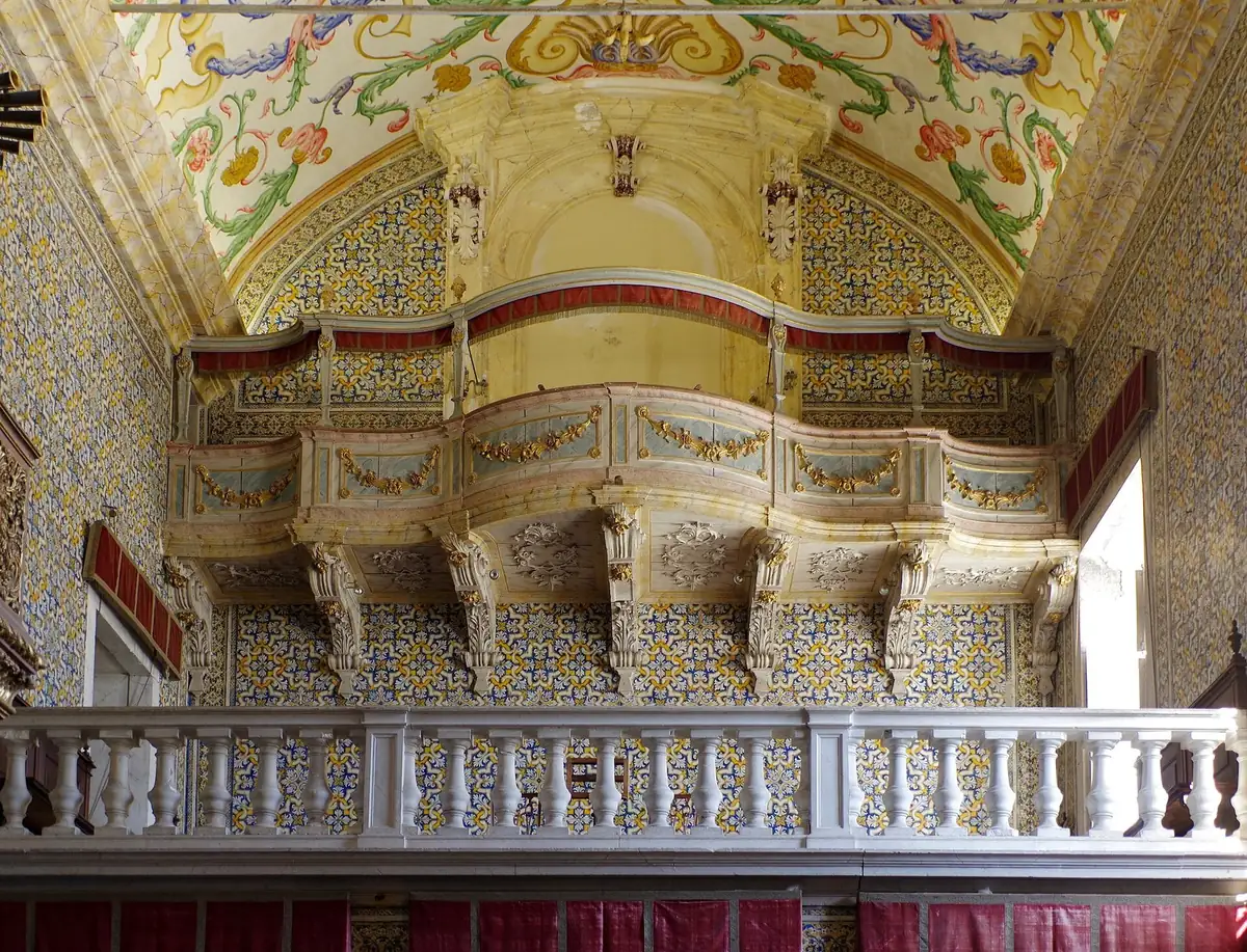 Blue-and-white tiled walls and gilded altarpiece inside the Capela de S&atilde;o Miguel, Coimbra