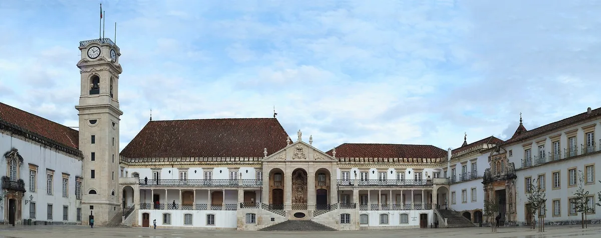 Students crossing the Pa&ccedil;o das Escolas courtyard below the University of Coimbra clock tower