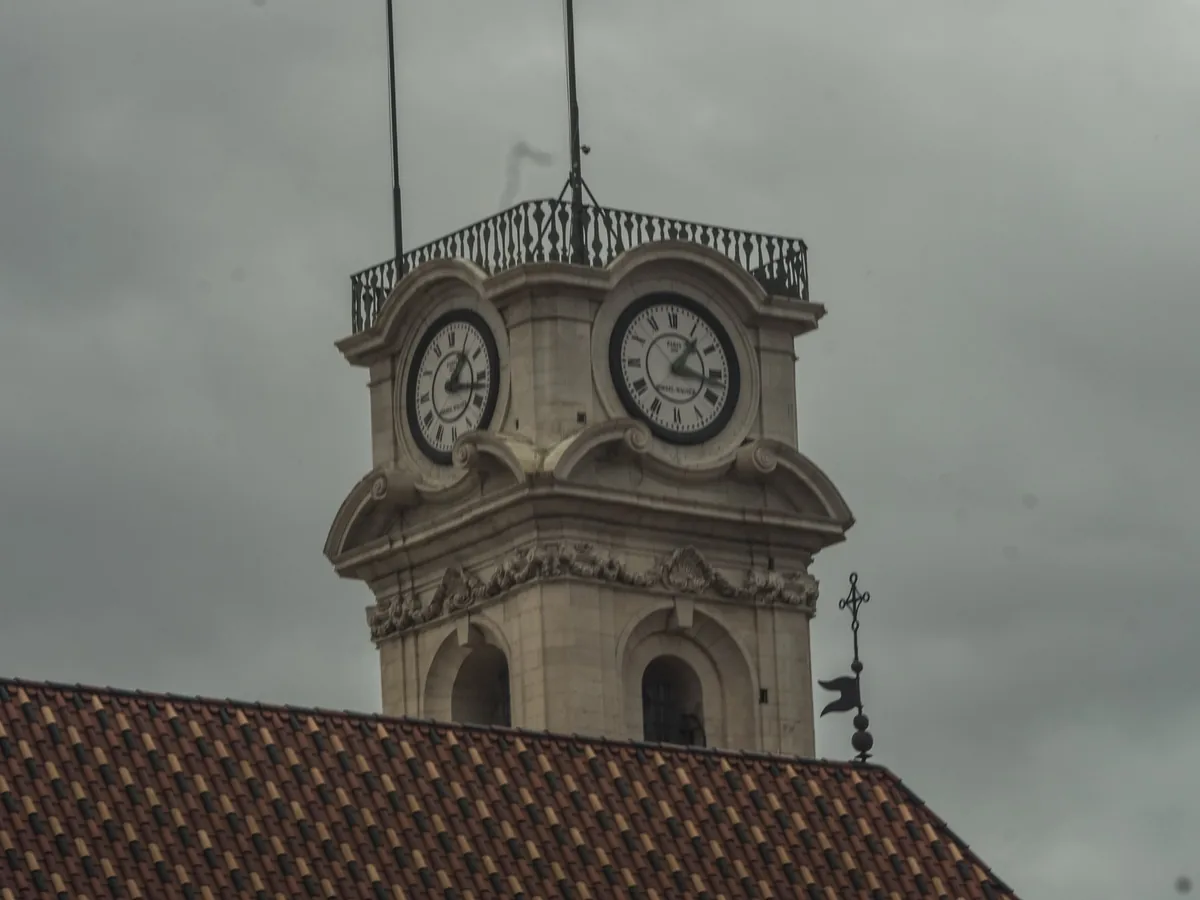 The baroque clock tower of the University of Coimbra above the Paço das Escolas